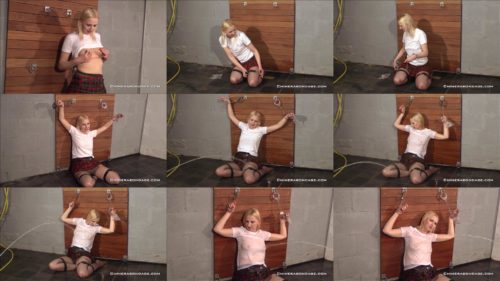 Tracey Lain Cuffed  by herself  to the wall using black leather straps and two sets of handcuff 
