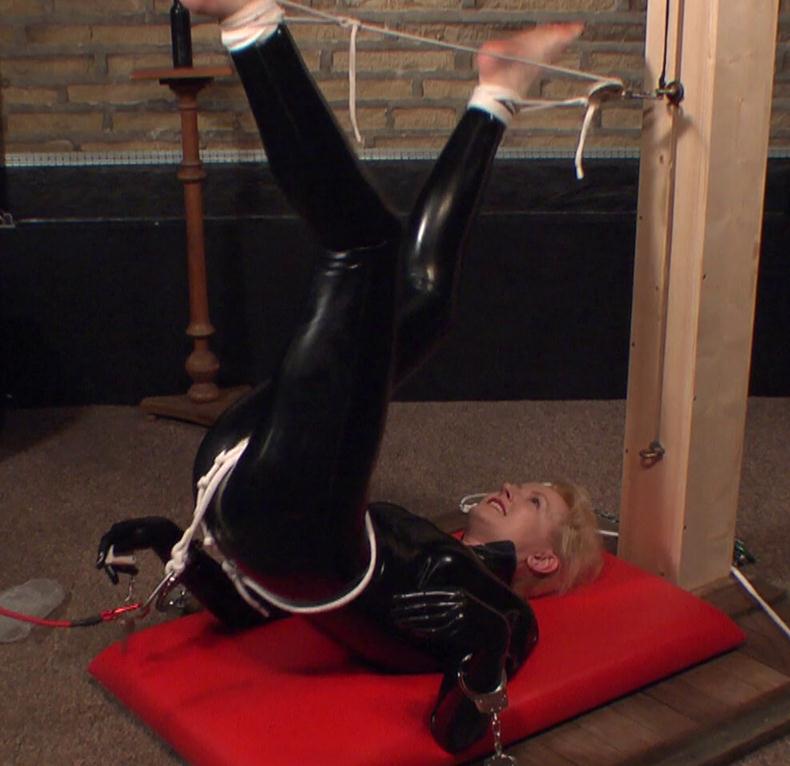 Latex bondage - Tied Anita De Bauch up in skin tight black latex with crotch rope and metal cuffs. She is doing gym exercises and enjoying her bondage - Self bondage
