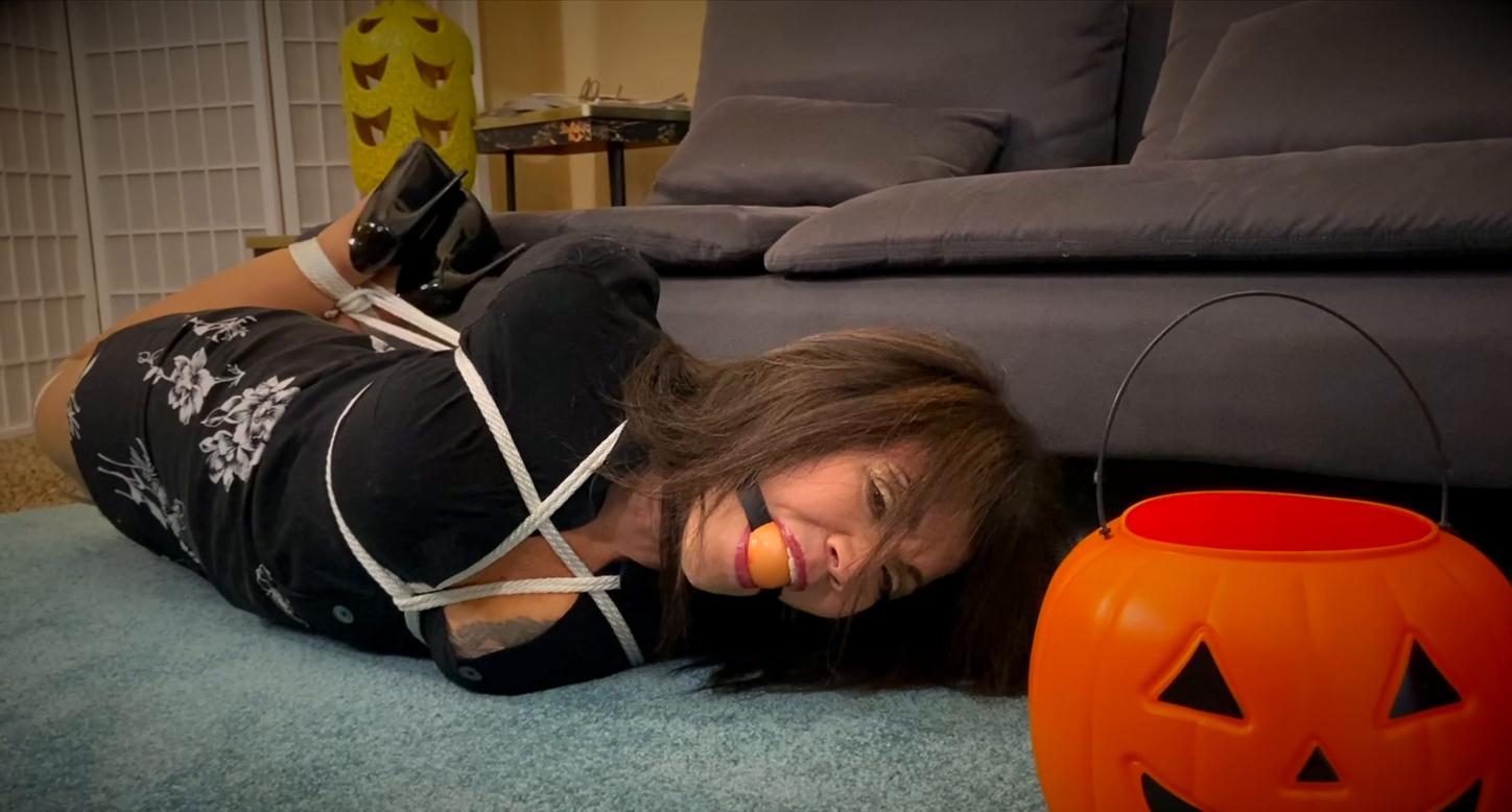 Nyxon and milf GiGi is hogtied and bound tightly with orange ballgag… Halloween Scrooge Gets The Ultimate Trick