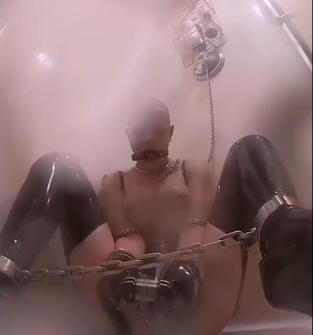 Latex Bondage – Latex Shower – Gagged, belted, and shackled Rachel Greyhound is chained to the shower rack - Sexy Latex