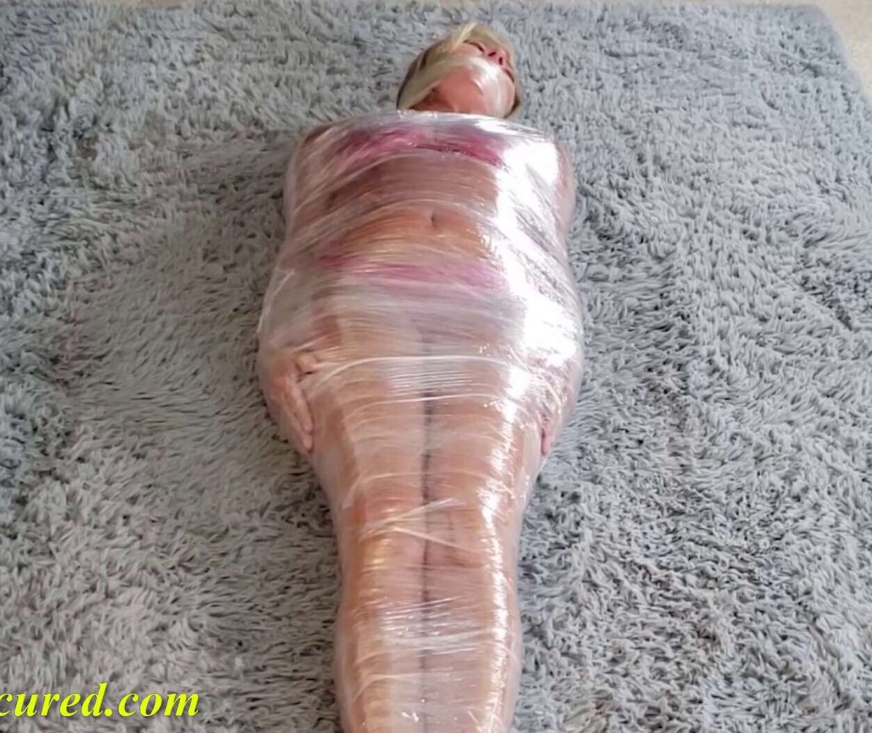 Tape Bondage - Dakkota is Wrapped and Zipped in tight plastic - Mummification Bondage