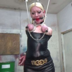 Stretched up by her brutally bound swollen tits